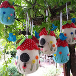 Load image into Gallery viewer, six felt birdhouse pincushions hanging in a tree
