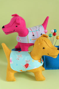 Two felt dogs wearing coats