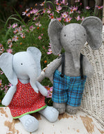 Load image into Gallery viewer, two grey stuffed toy elephants wearing clothes
