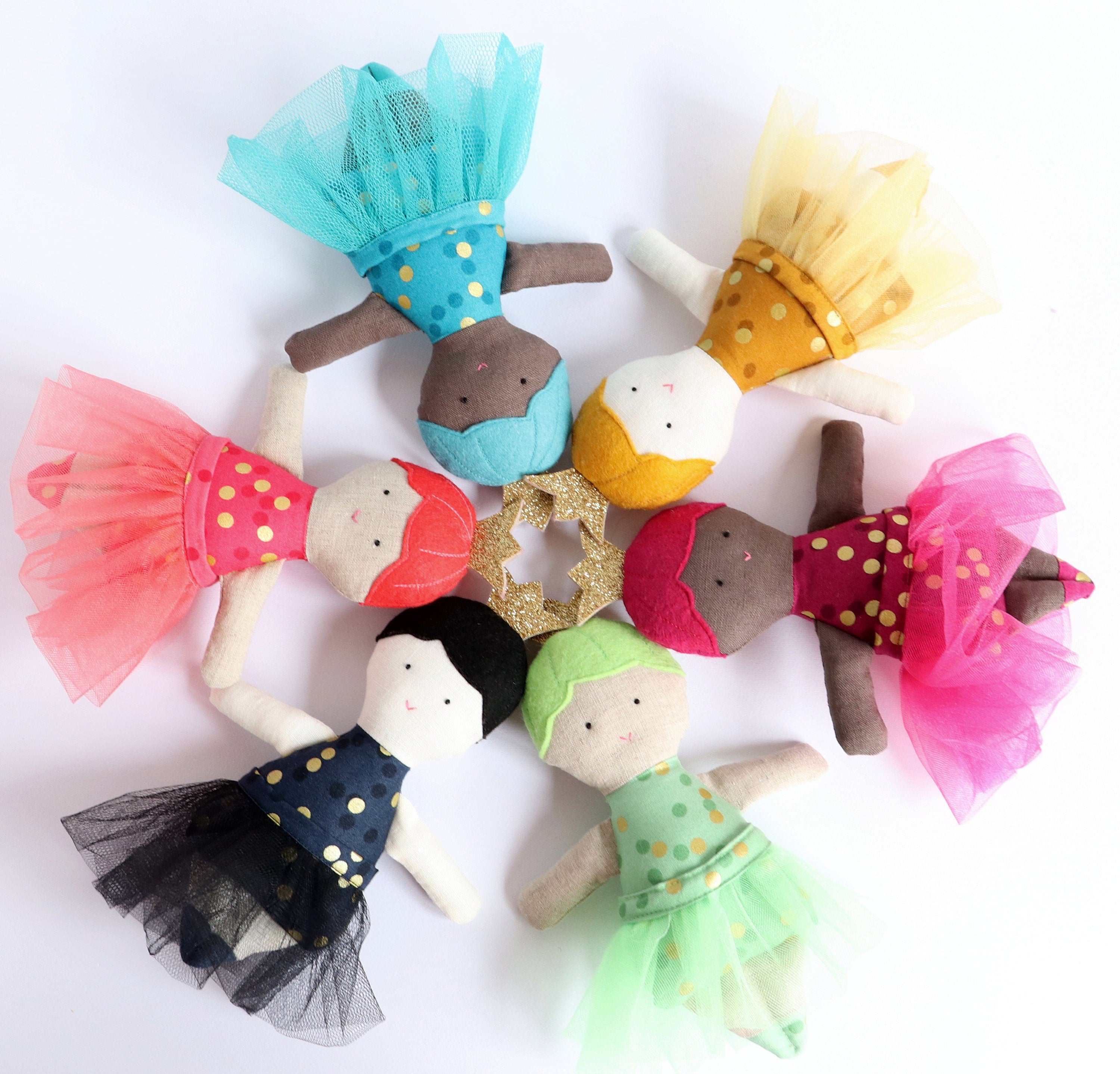 6 small dolls wearing tutus