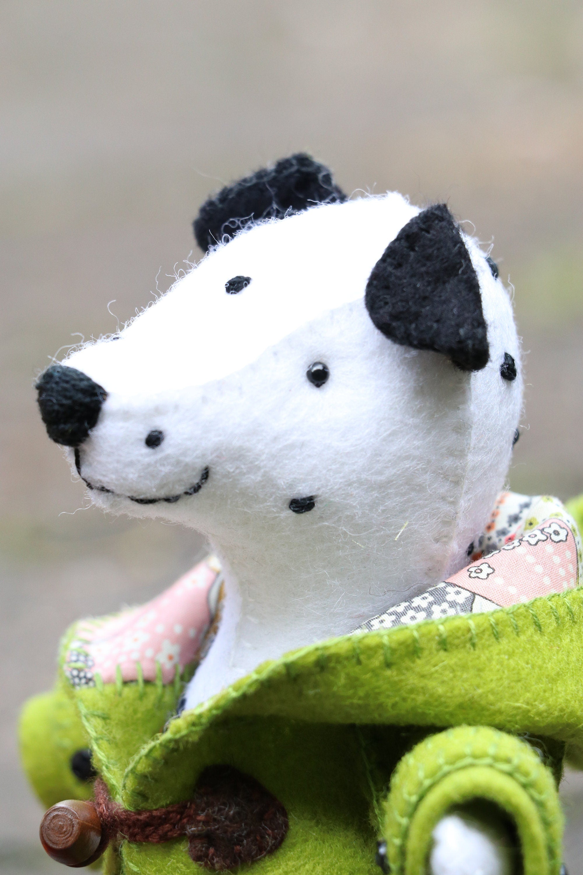 felt dalmation wearing a green coat