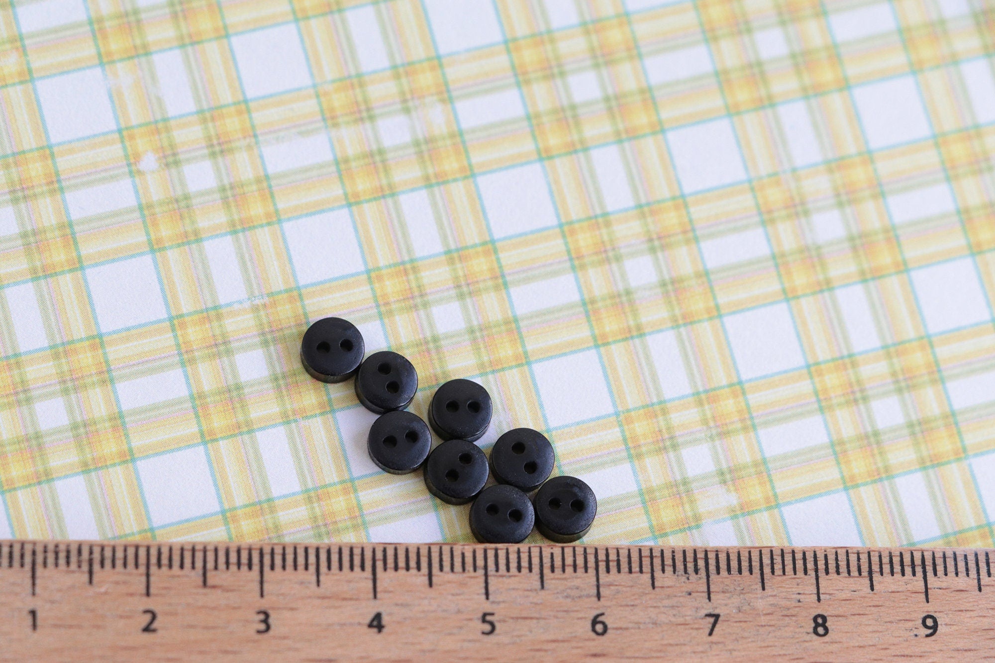 A group of black buttons for toymaking